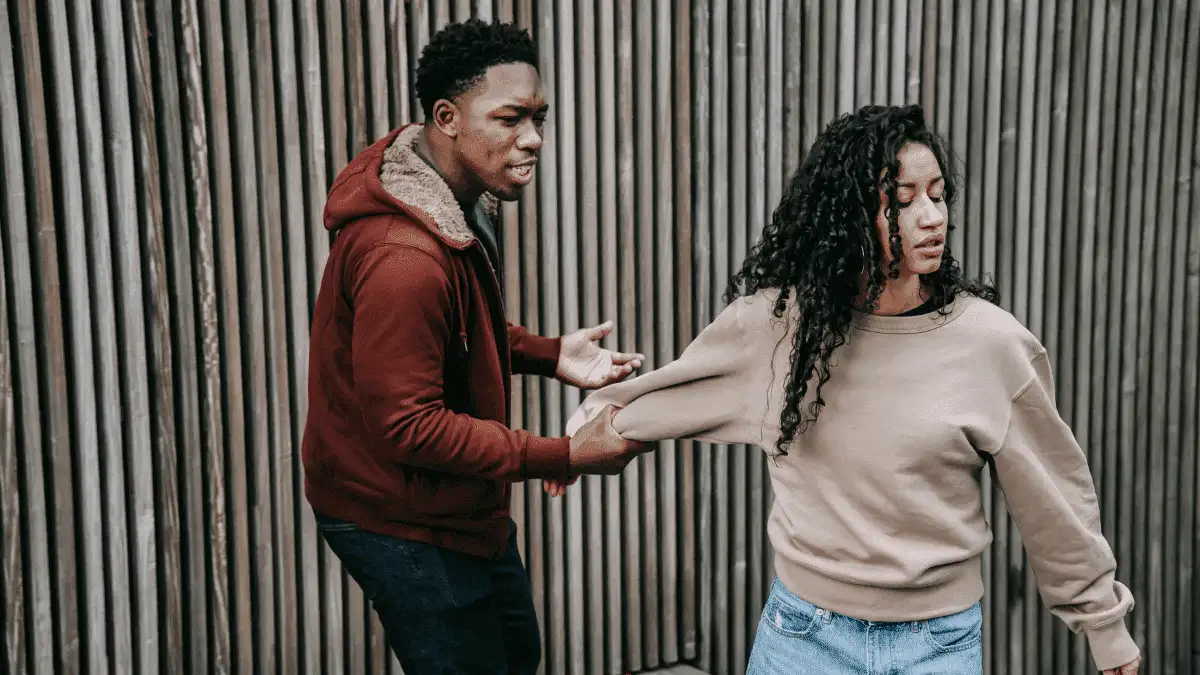 A girl trying to walk away from a guy to show signs she doesn't want a relationship with you