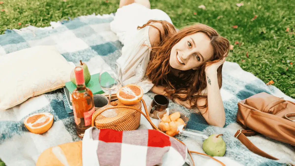 Woman lying on blanket showing how to date yourself