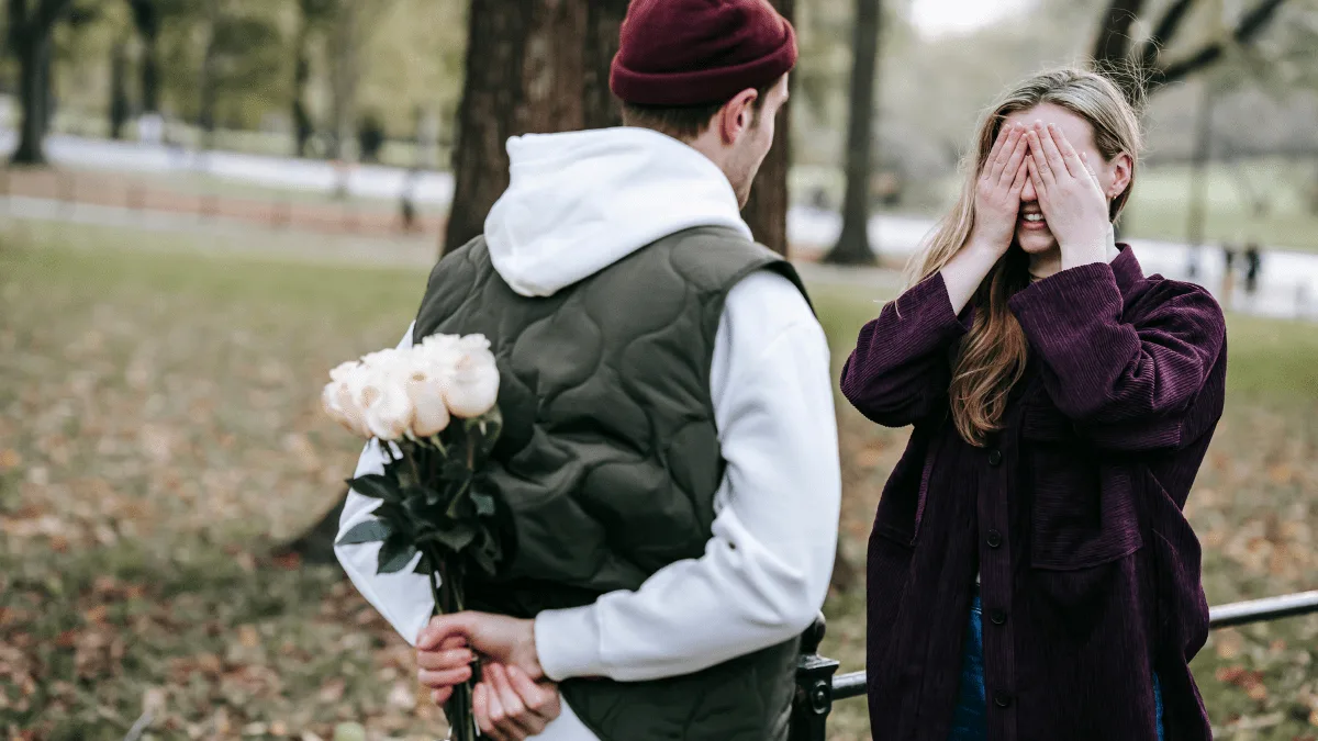 A guy giving a girl a surprise gift