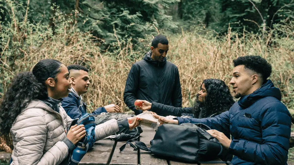 Friends sharing food to illustrate the benefits of having friends