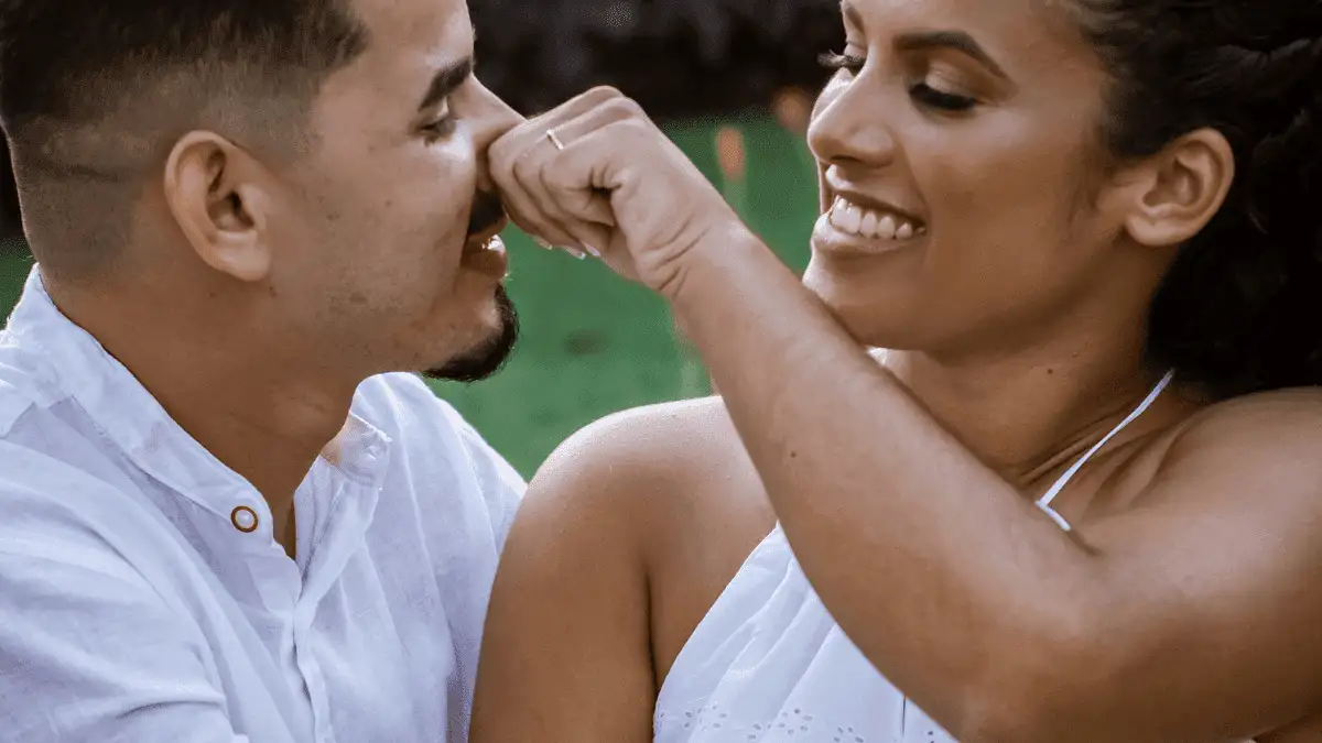 Cheerful couple hugging in park during date