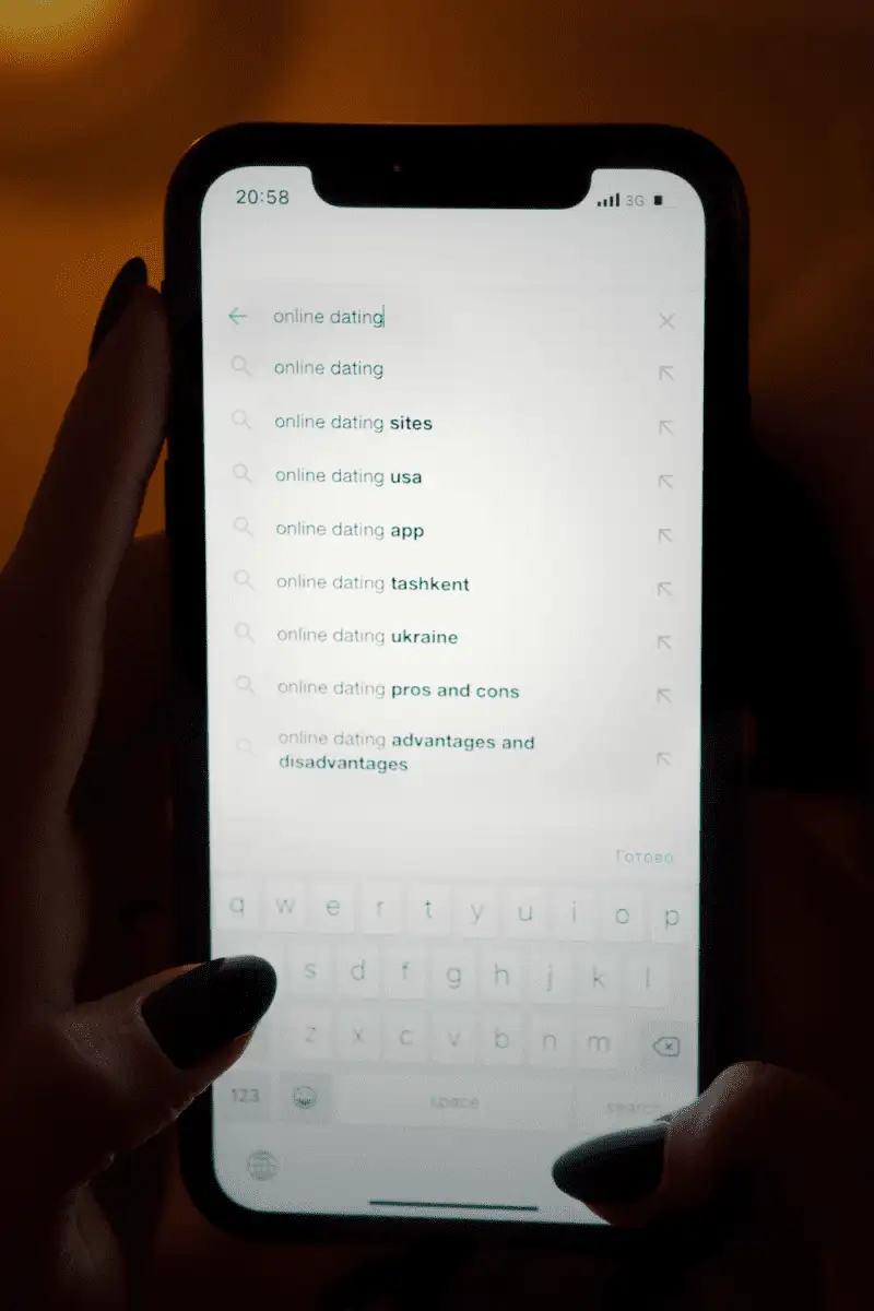 A hand browsing online dating websites