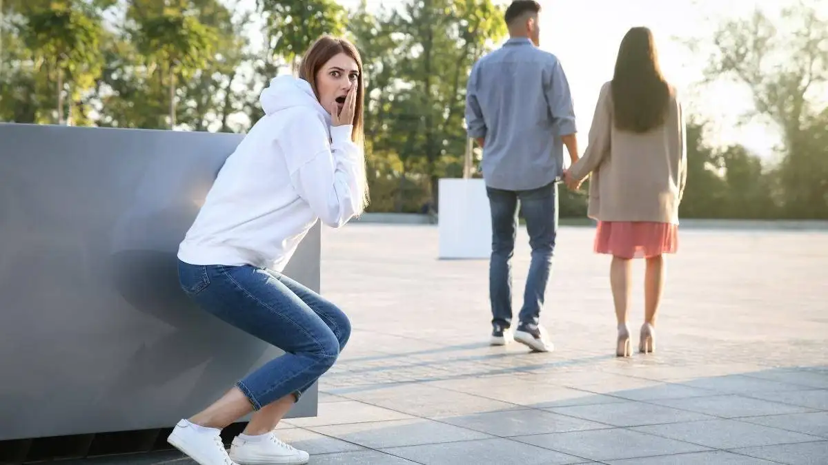 A girl feeling jealous as she sees her ex-boyfriend with another girl