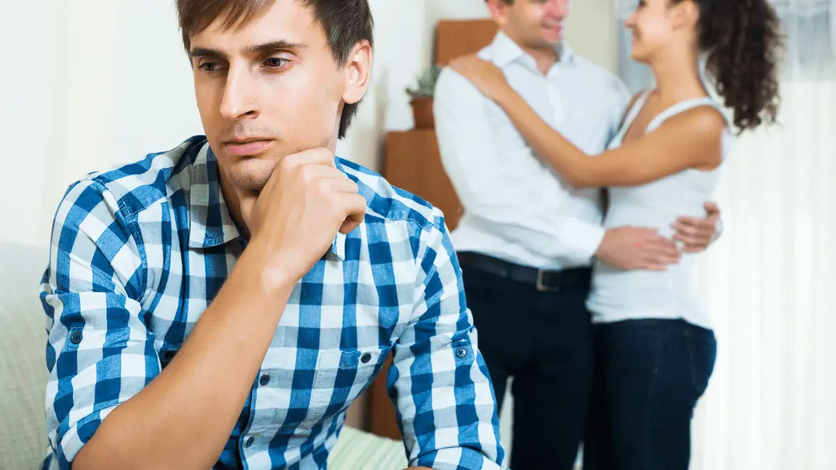 A guy's ex hugging another guy
