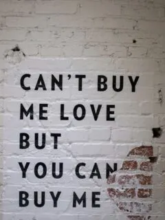 A white brick wall with a quote on it